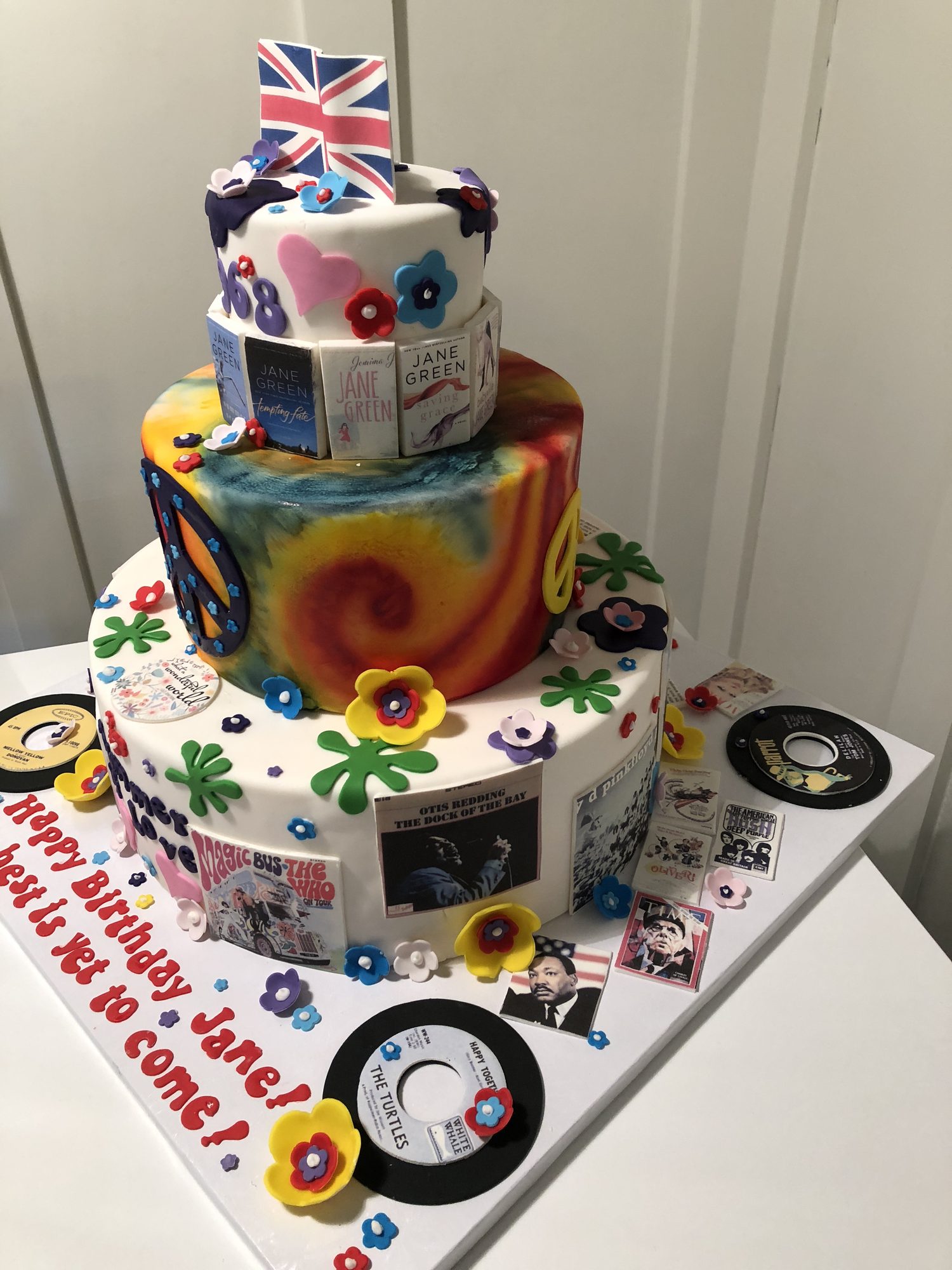 Tiered 1960s tribute birthday cake with tie-dye, records and a Union Jack